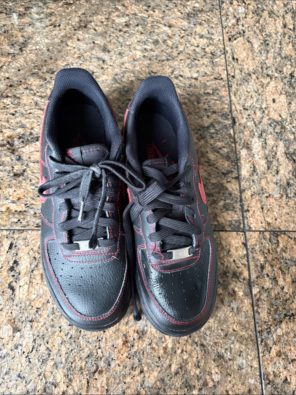 Nike Kids Black Sneakers with Red Stitching and Swoosh Accent